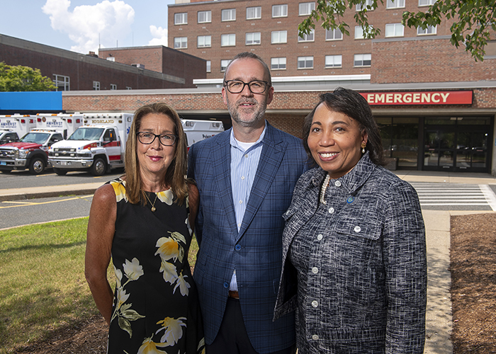 Three people in front of ER